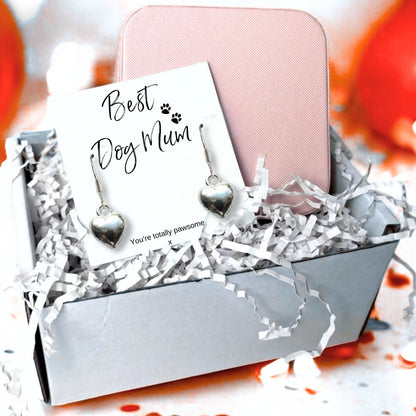 Silver plated puffed heart drop earrings on a Best Dog Mum card reading You're totally pawsome, presented in a gift box with a pink zip up jewellery case and shredded paper filler.