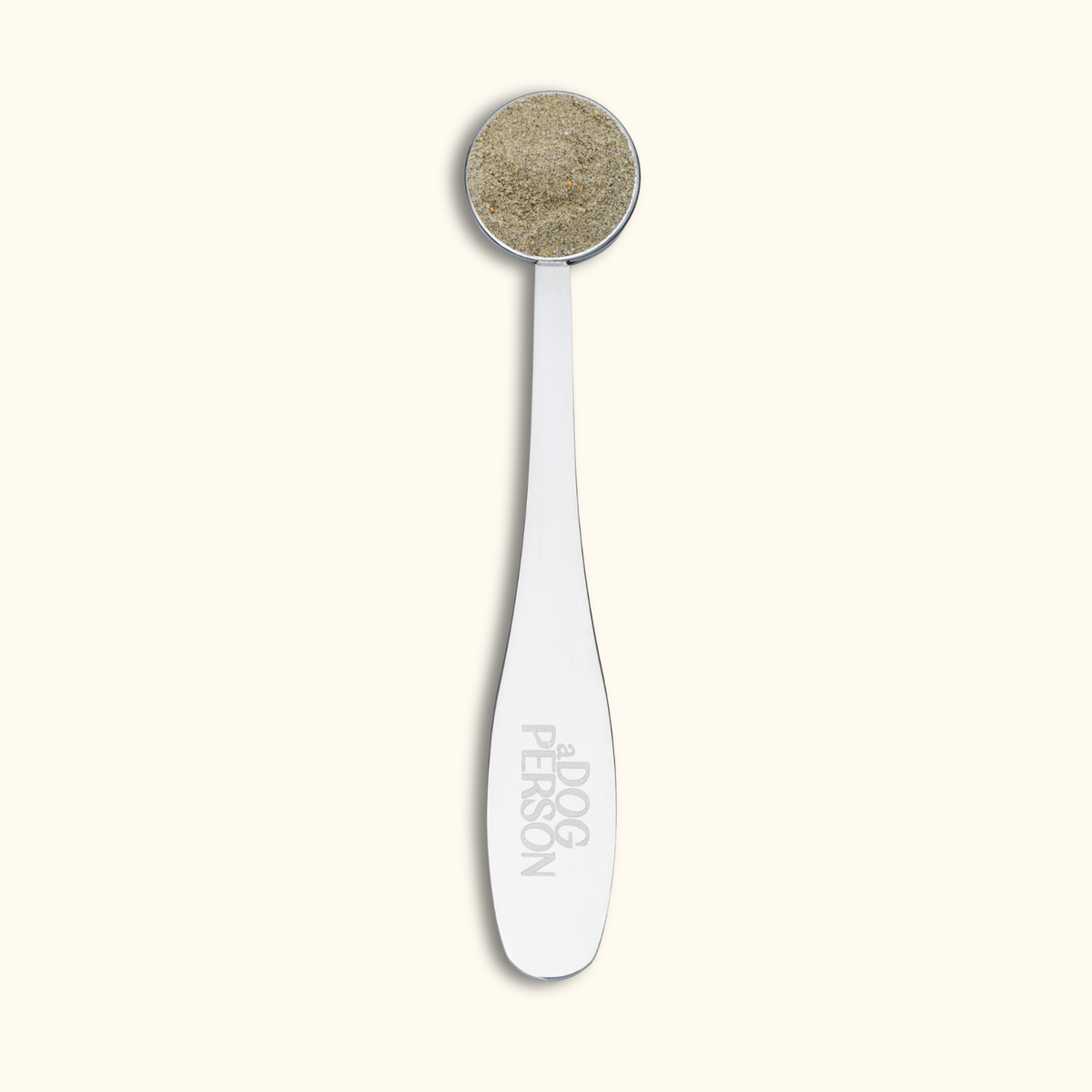 a Dog Person silver measuring scoop for dog supplement powder
