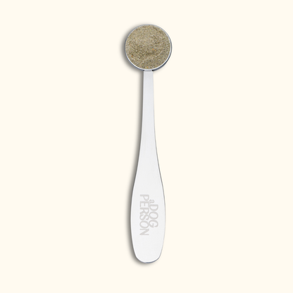 a Dog Person silver measuring scoop for dog supplement powder