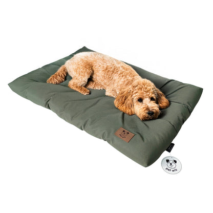 Dog lying on the olive waterproof dog crate bed, side view