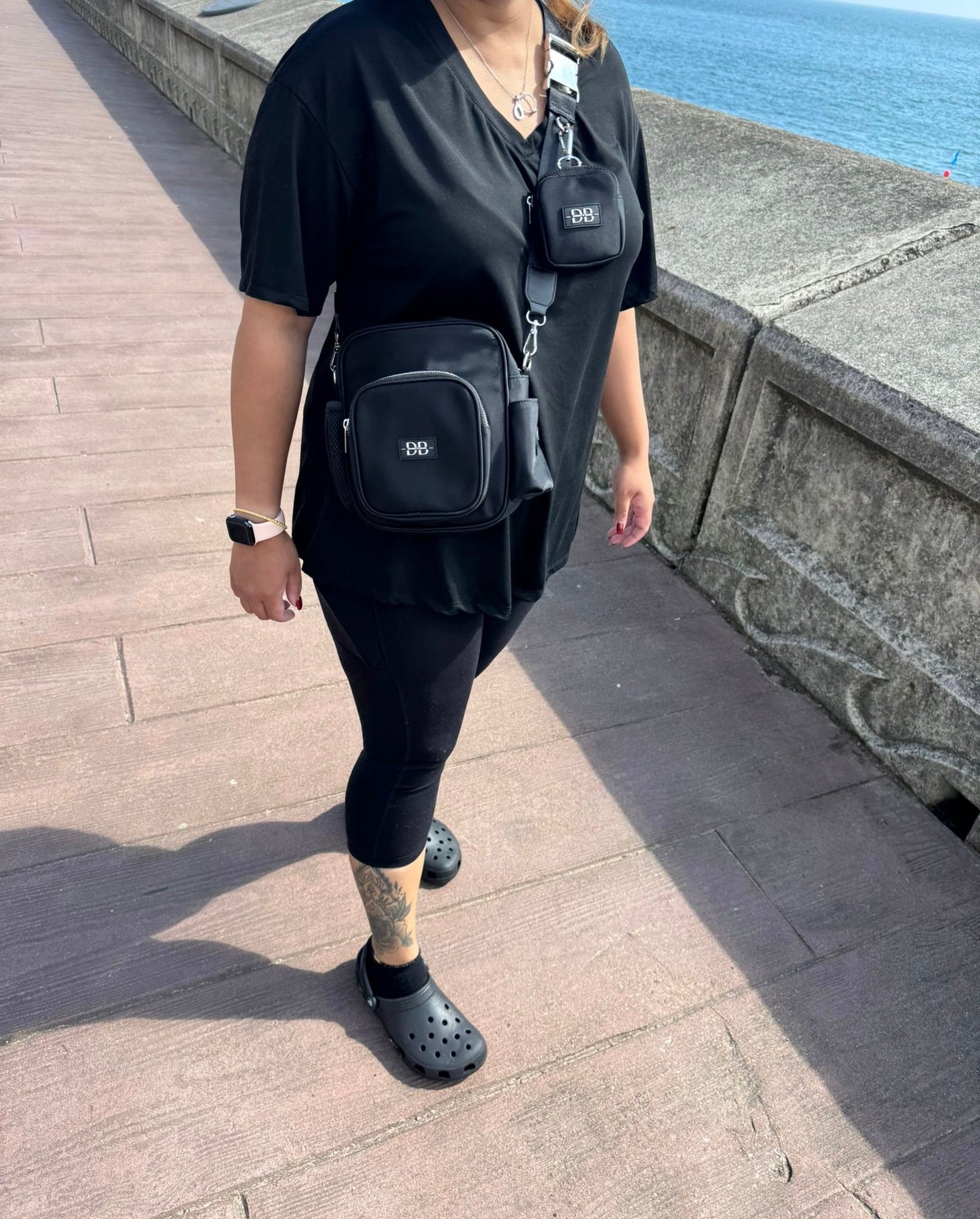 The OG worn crossbody in black, with the matching treat pouch clipped to the strap