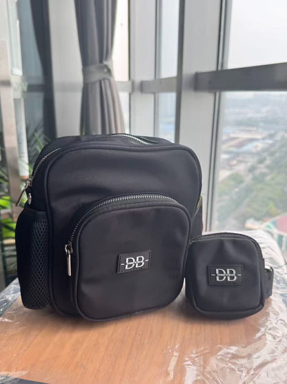 The OG black dog walking bag beside its matching treat pouch, with the stretch mesh bottle pocket in view