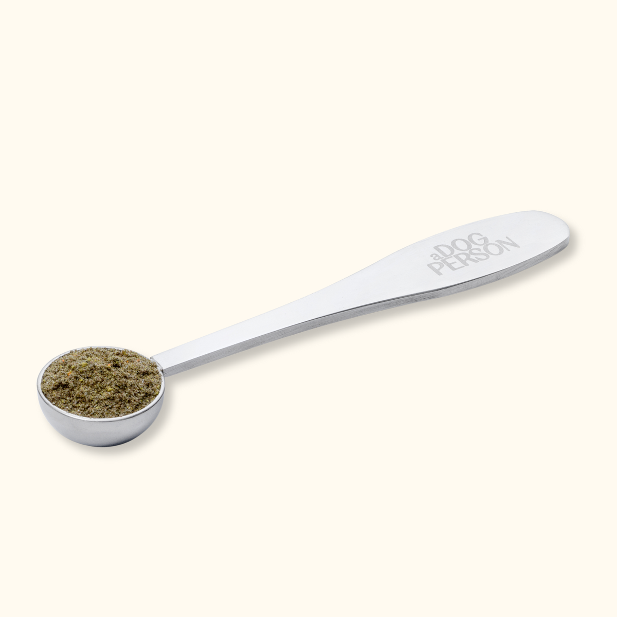 Silver scoop filled with a single daily dose of supplement powder