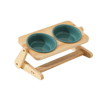 Duke & Milo adjustable wooden dog bowl stand in green, holding two ceramic bowls