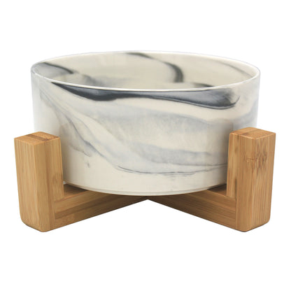 Duke & Milo raised ceramic dog bowl in marble grey, sitting in its bamboo stand