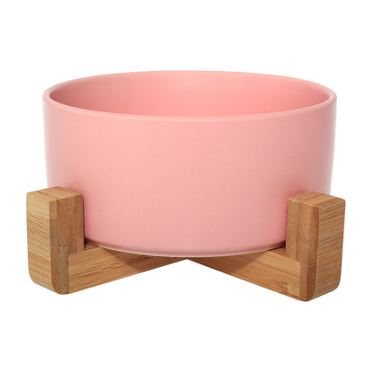 Duke & Milo raised ceramic dog bowl in pink, sitting in its bamboo stand