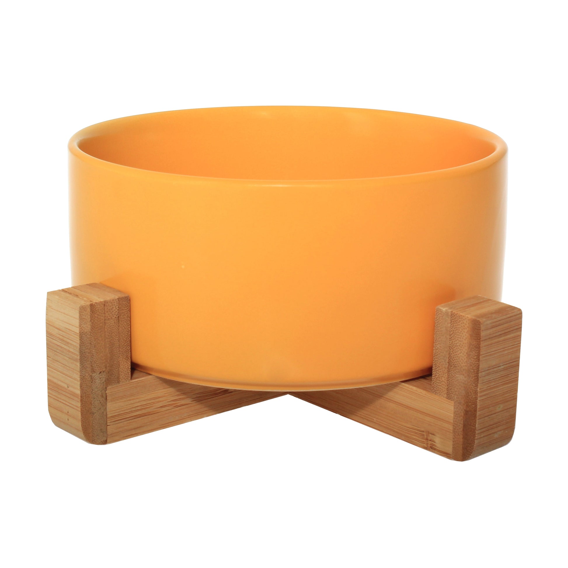 Duke & Milo raised ceramic dog bowl in yellow, sitting in its bamboo stand