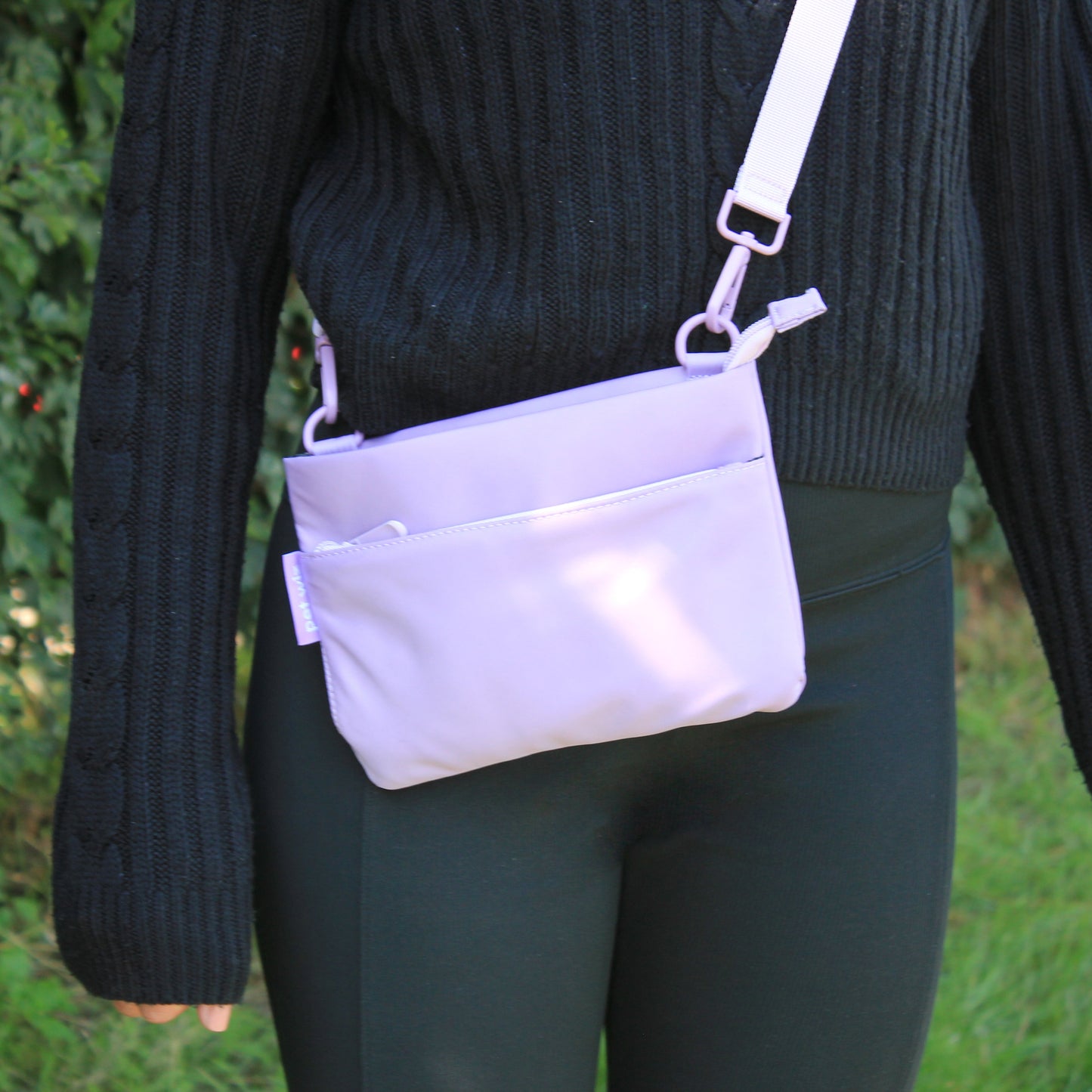 Lilac crossbody dog walking bag worn across the body on a walk