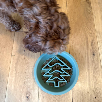 Dog eating from the festive Christmas tree slow feeder dog bowl