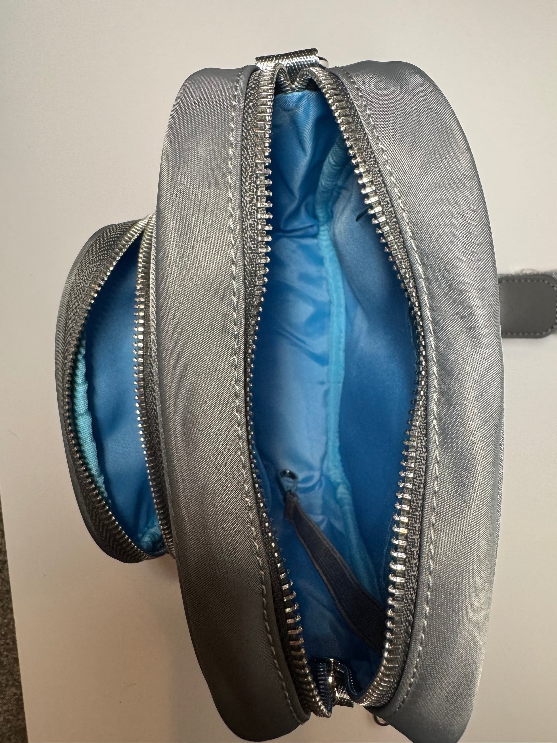 The PEBBLE grey dog walking bag unzipped, showing the bright blue lined main compartment and inner zip pocket