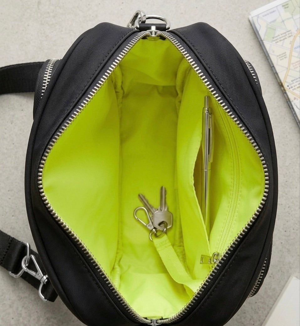 The OG unzipped to show the neon yellow lining, inner zip pocket, keys and a pen