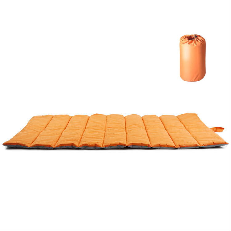 Orange roll-up dog travel mat laid flat beside its matching carry case