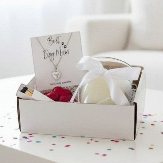 Best Dog Mum gift hamper open in its white box with the heart necklace on its card, a ribbon tied candle, matches and foil wrapped chocolate hearts