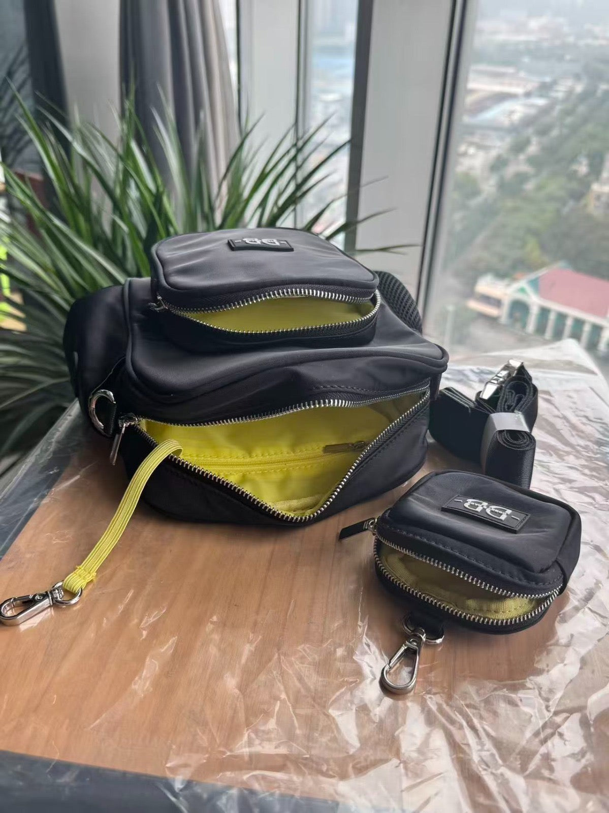 The OG black bag and treat pouch opened to show the neon yellow lined compartments