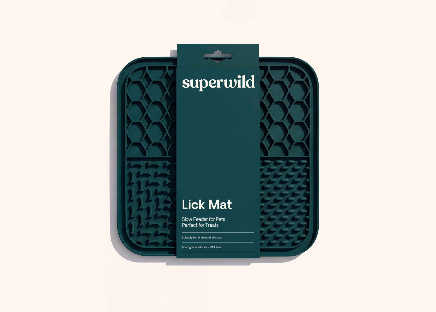 Superwild lick mat for dogs in its retail sleeve, dark green silicone mat with four textured feeding sections