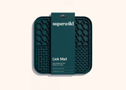 Superwild lick mat for dogs in its retail sleeve, dark green silicone mat with four textured feeding sections