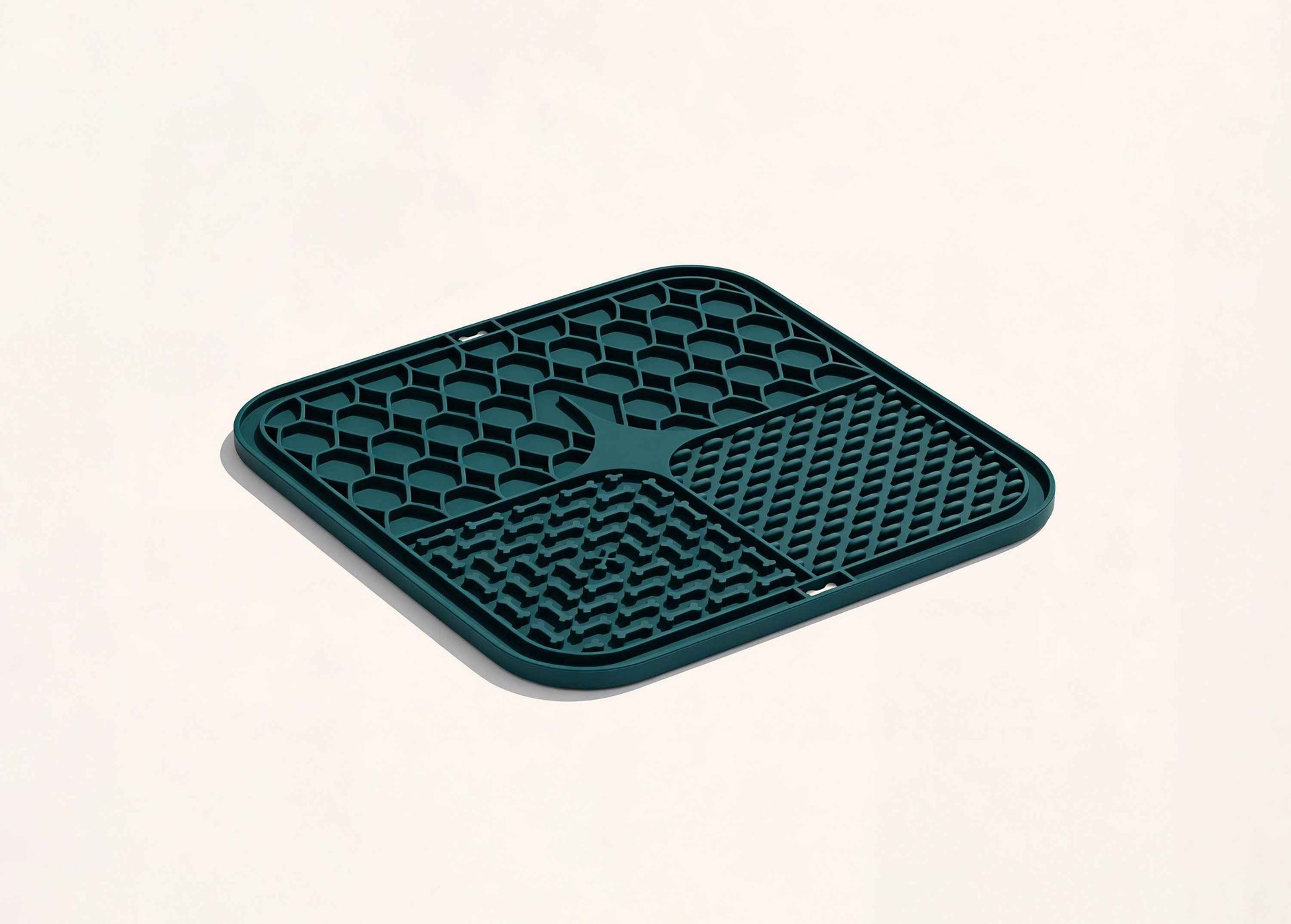 Superwild dog lick mat photographed at an angle, showing the four raised silicone patterns that slow eating